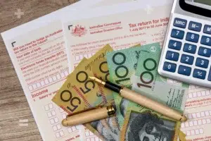 2025 calendar highlighting Tax Day on October 31, with tax forms and calculator in the foreground