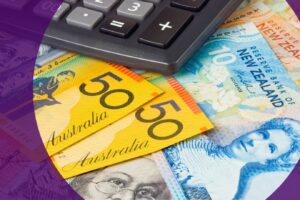 Income statement and income tax return forms by the Australian Taxation Office spread across a wooden desk, alongside Australian banknotes, a calculator displaying the figure 5860, and a gold pen used for completing tax documents