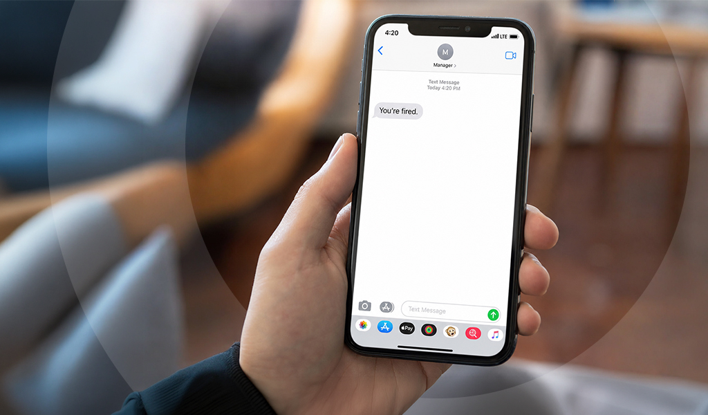 A smartphone displaying a "you're fired" message, representing the dismissal method at the centre of a Fair Work Australia case